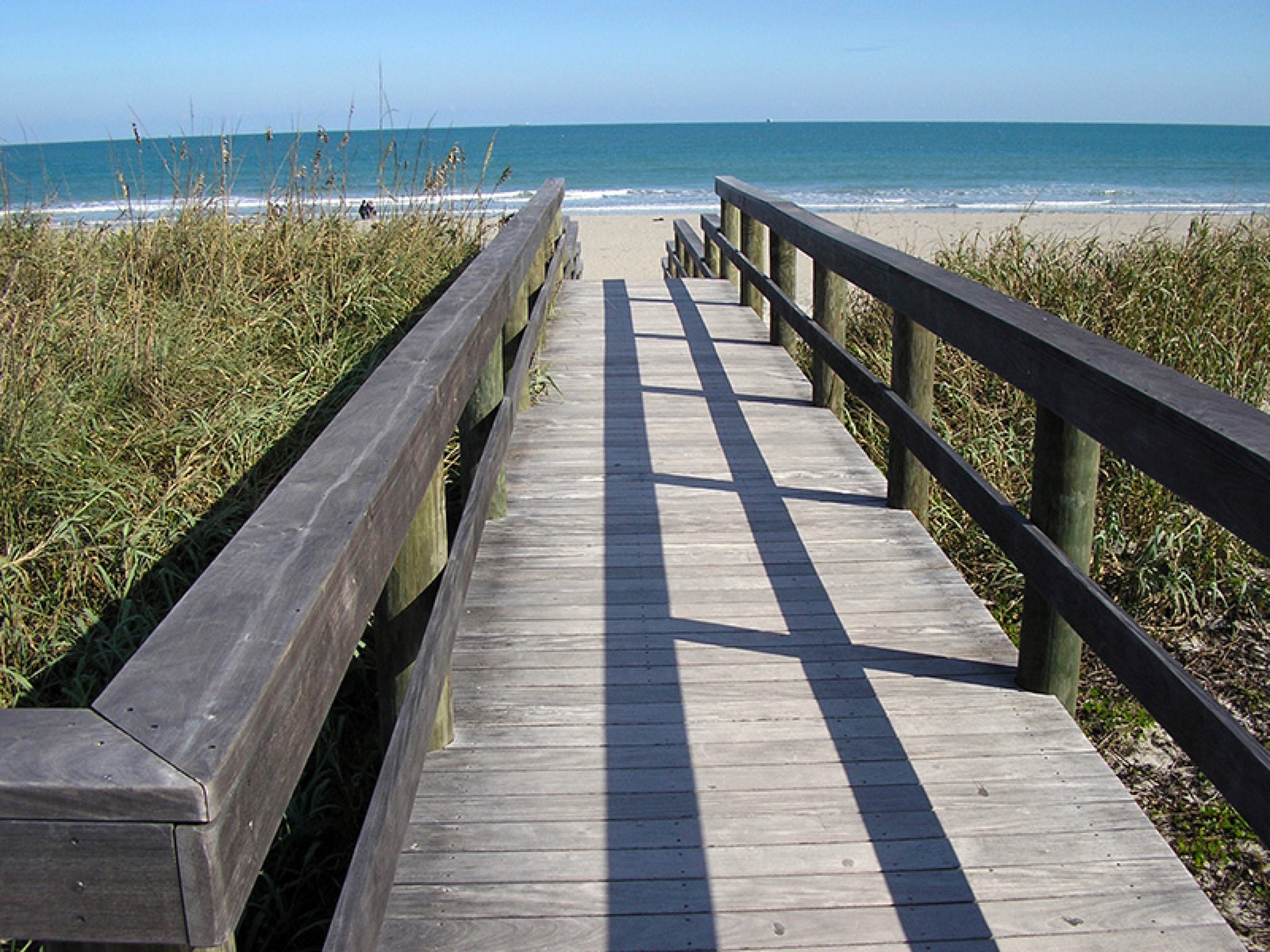 Tropical hardwood pier deck over open water