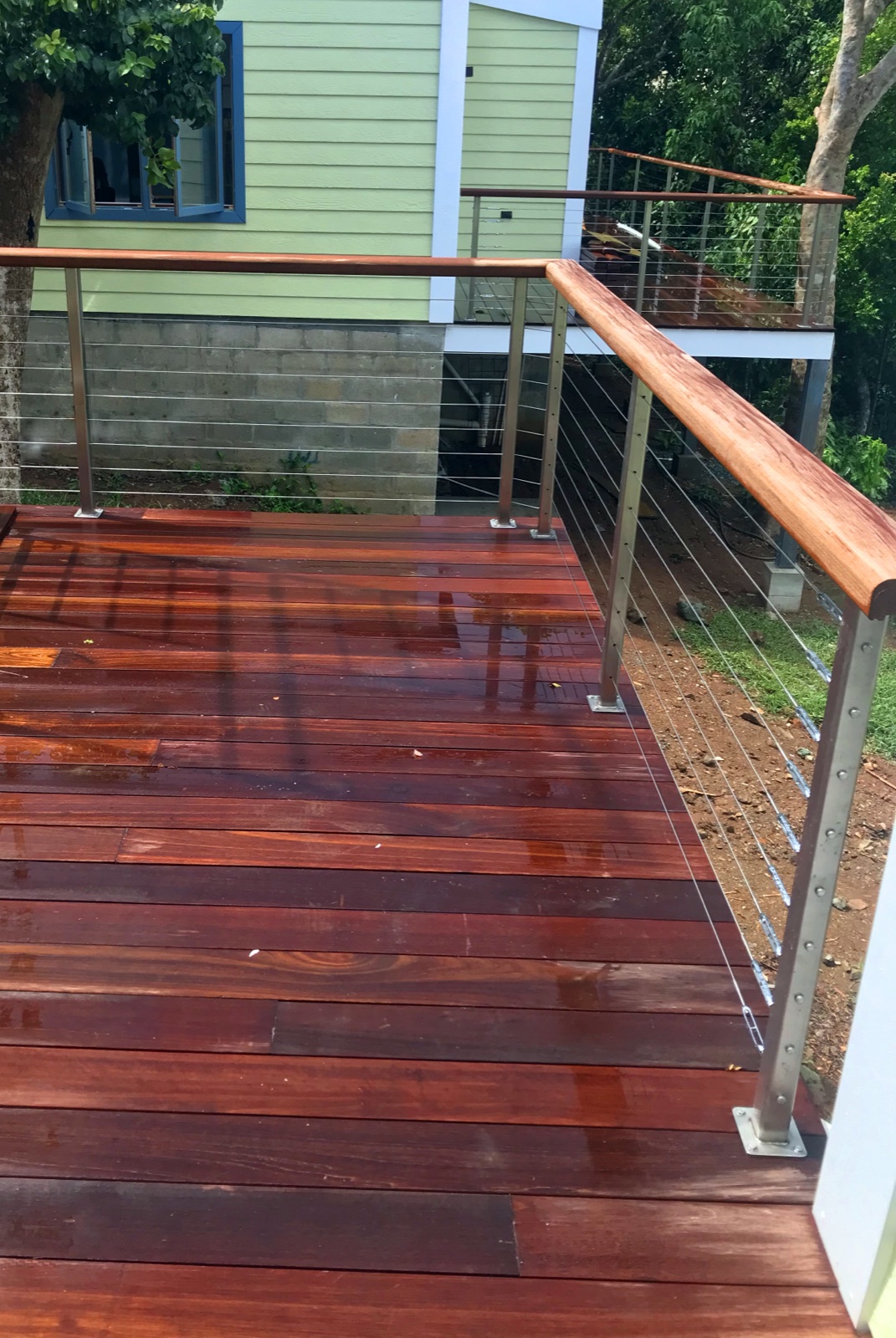 Rich tropical hardwood deck beside a beach house