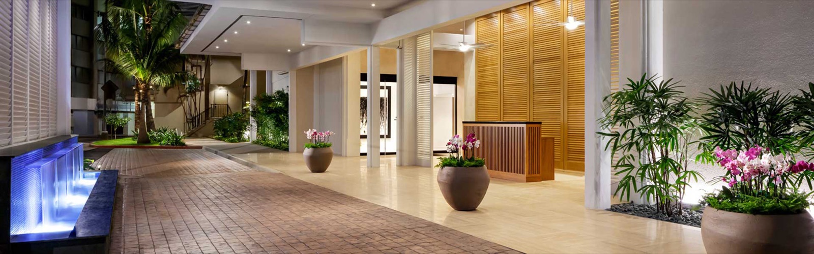Teak shutters carried up a tower elevation