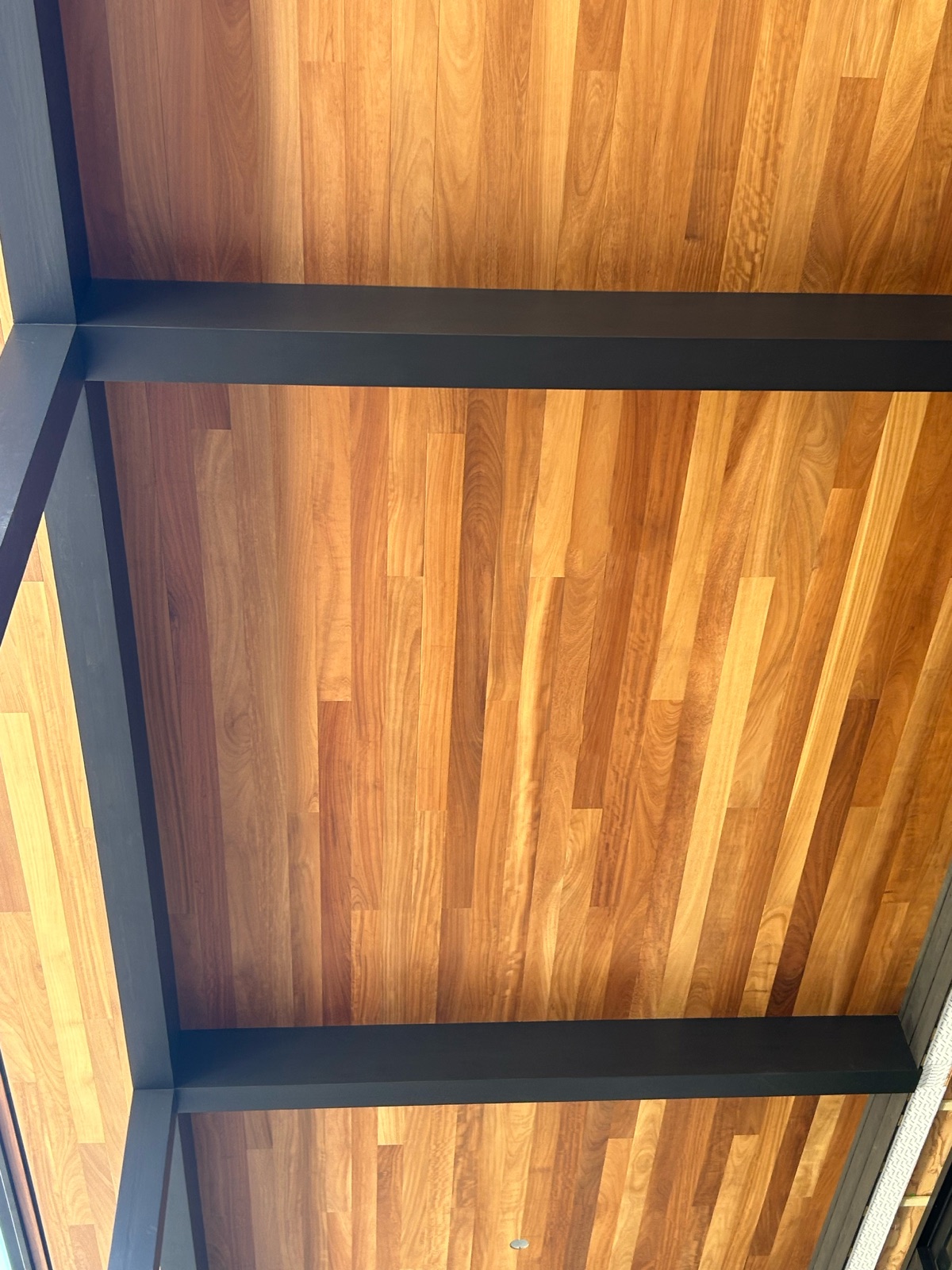 Iroko porch roof with the framing carried out to the eave