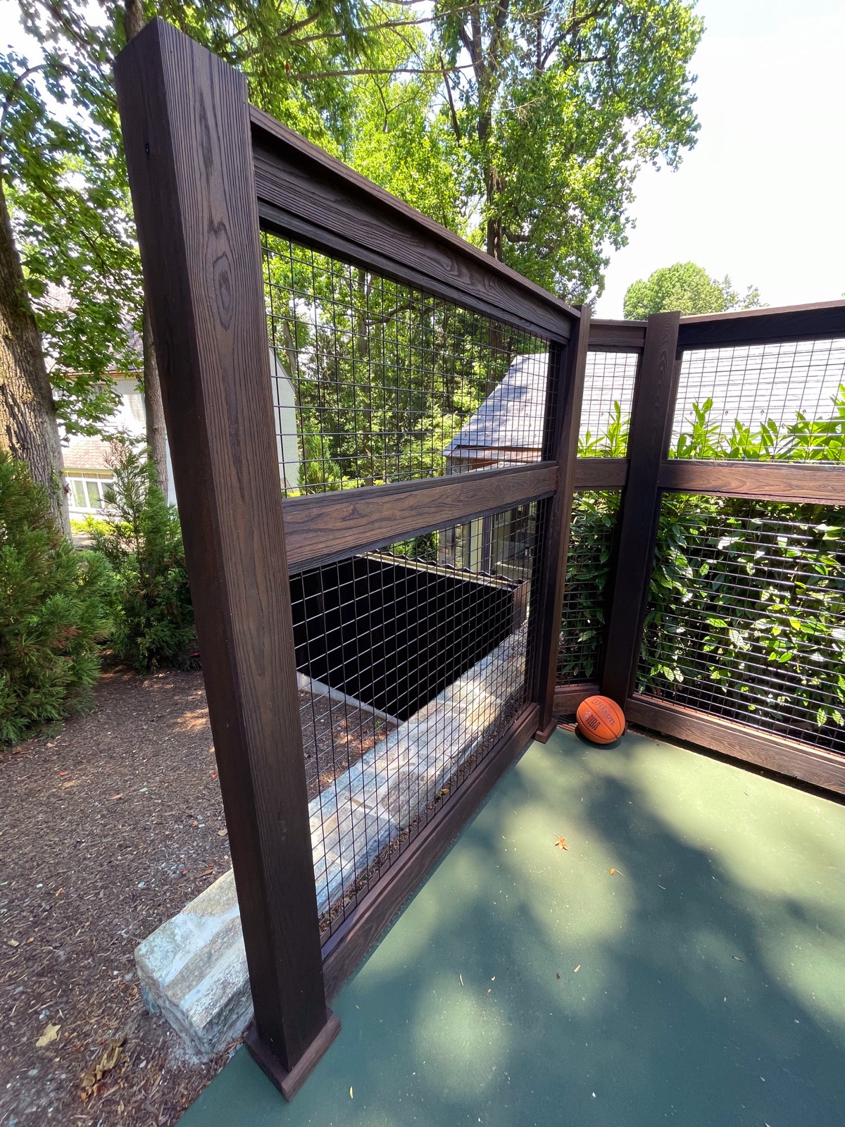 Hardwood fence and screen framing on a slope