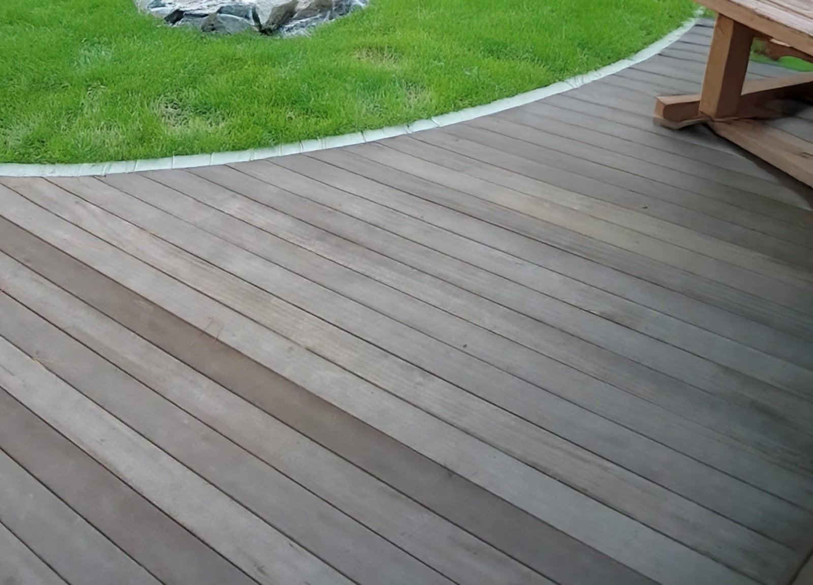 Curved tropical hardwood deck aged to silver gray
