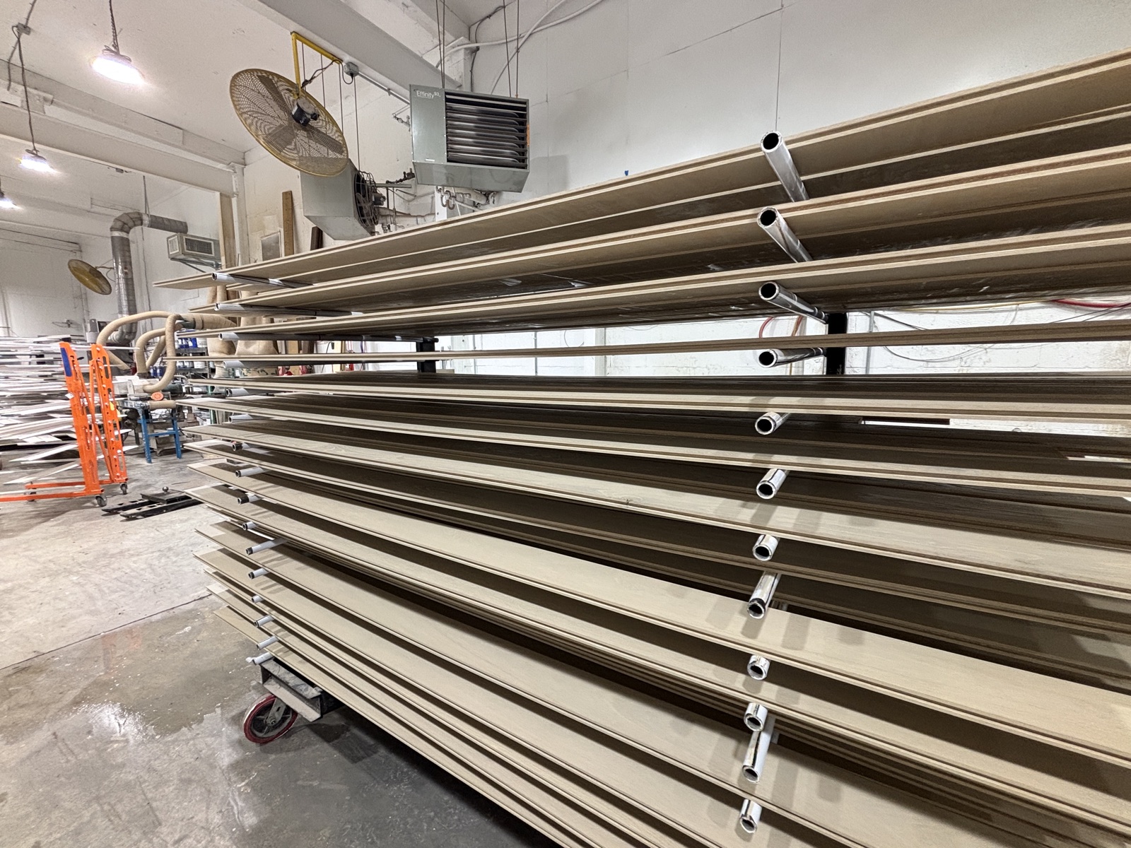 Drying rack loaded end to end with primed profile stock