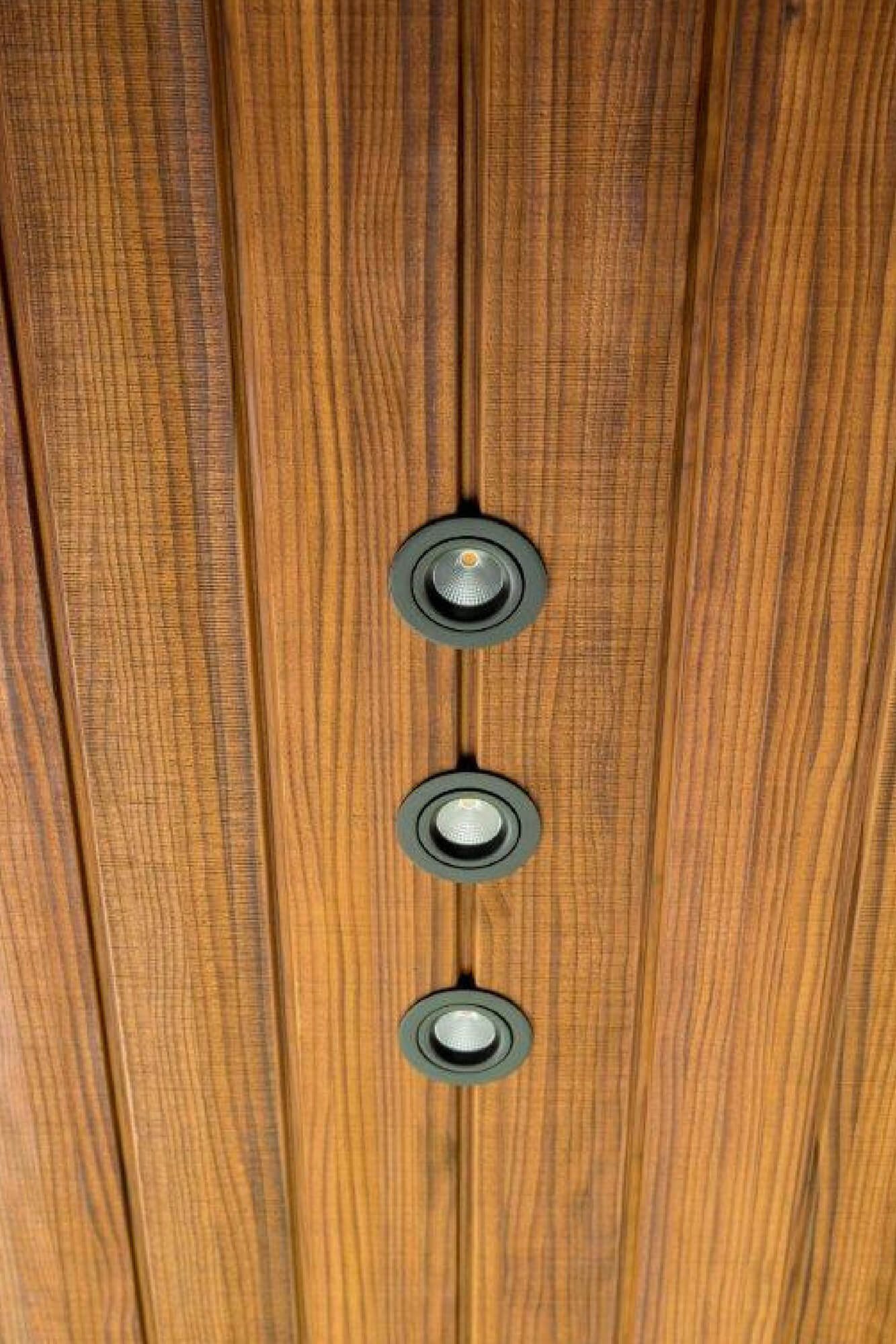 Teak panel with round hardware set into its face