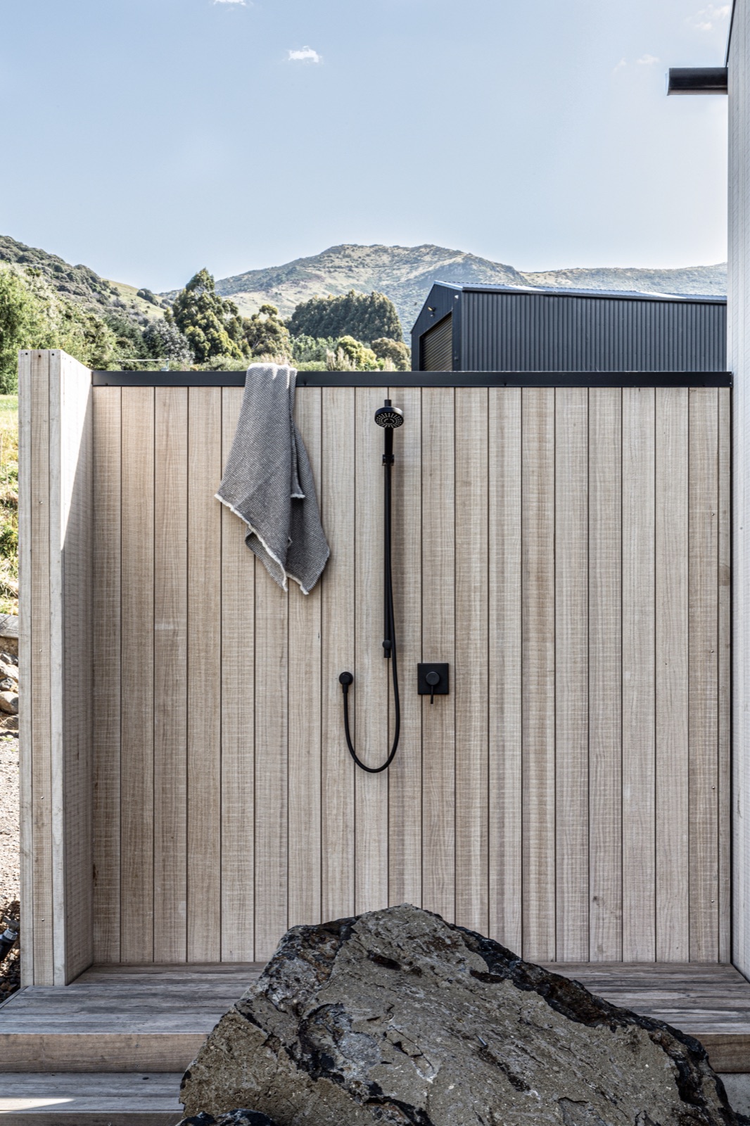 Modified wood cladding lining a wet outdoor enclosure