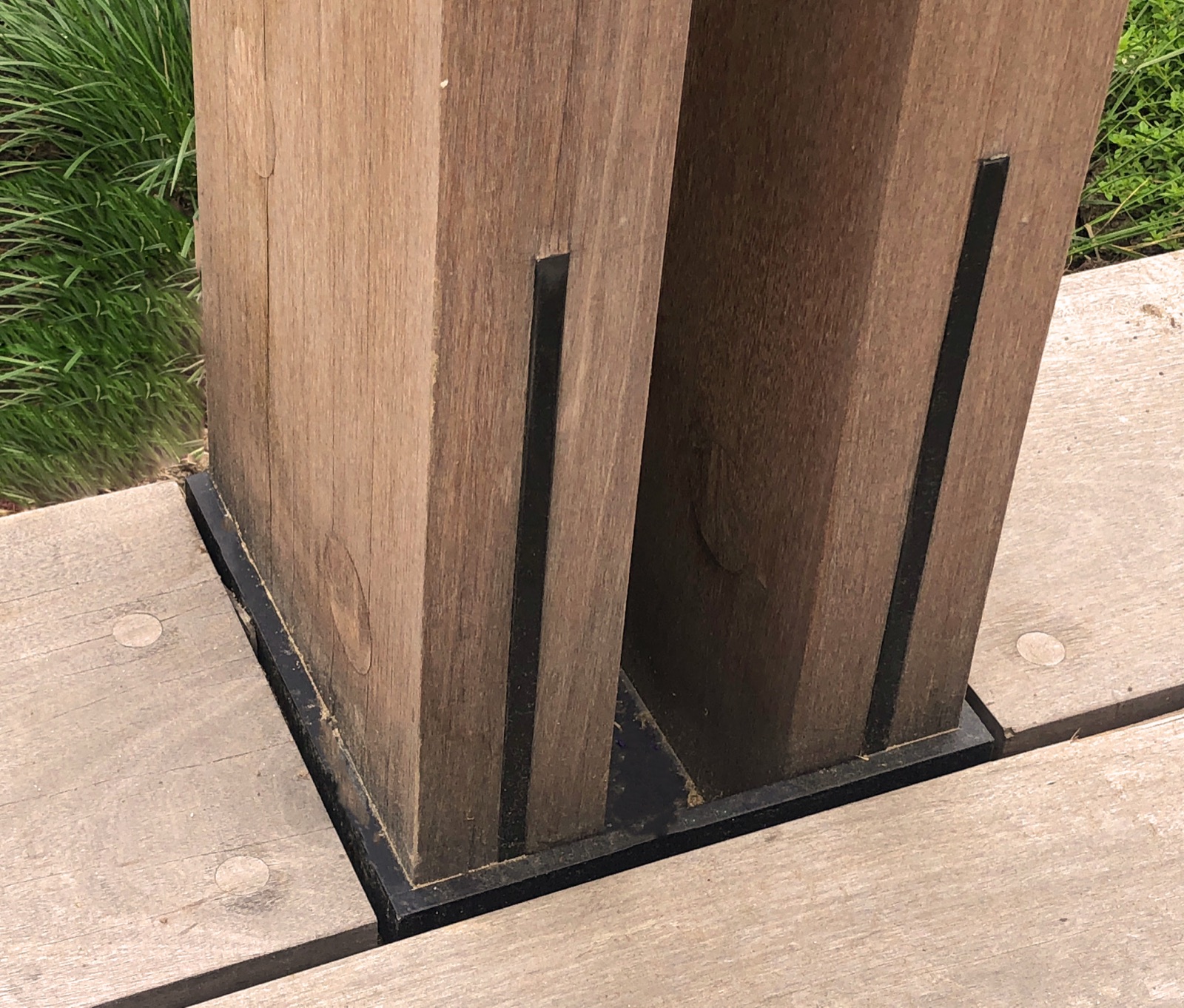 Pergola post base anchored to a hard surface