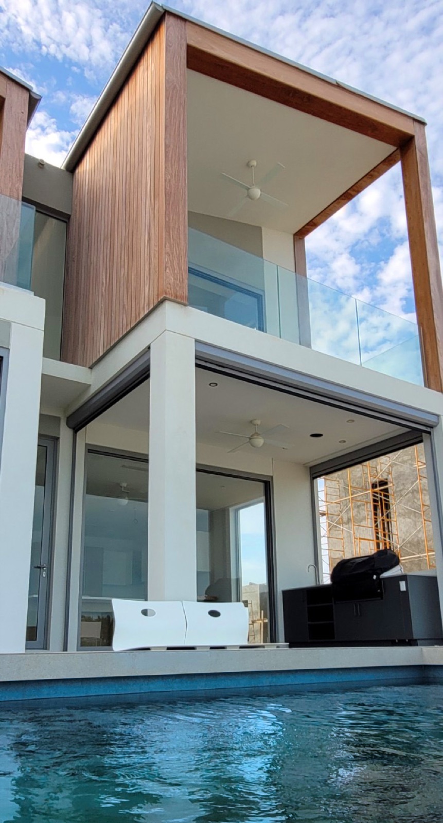 Wide board cladding coursing across a facade