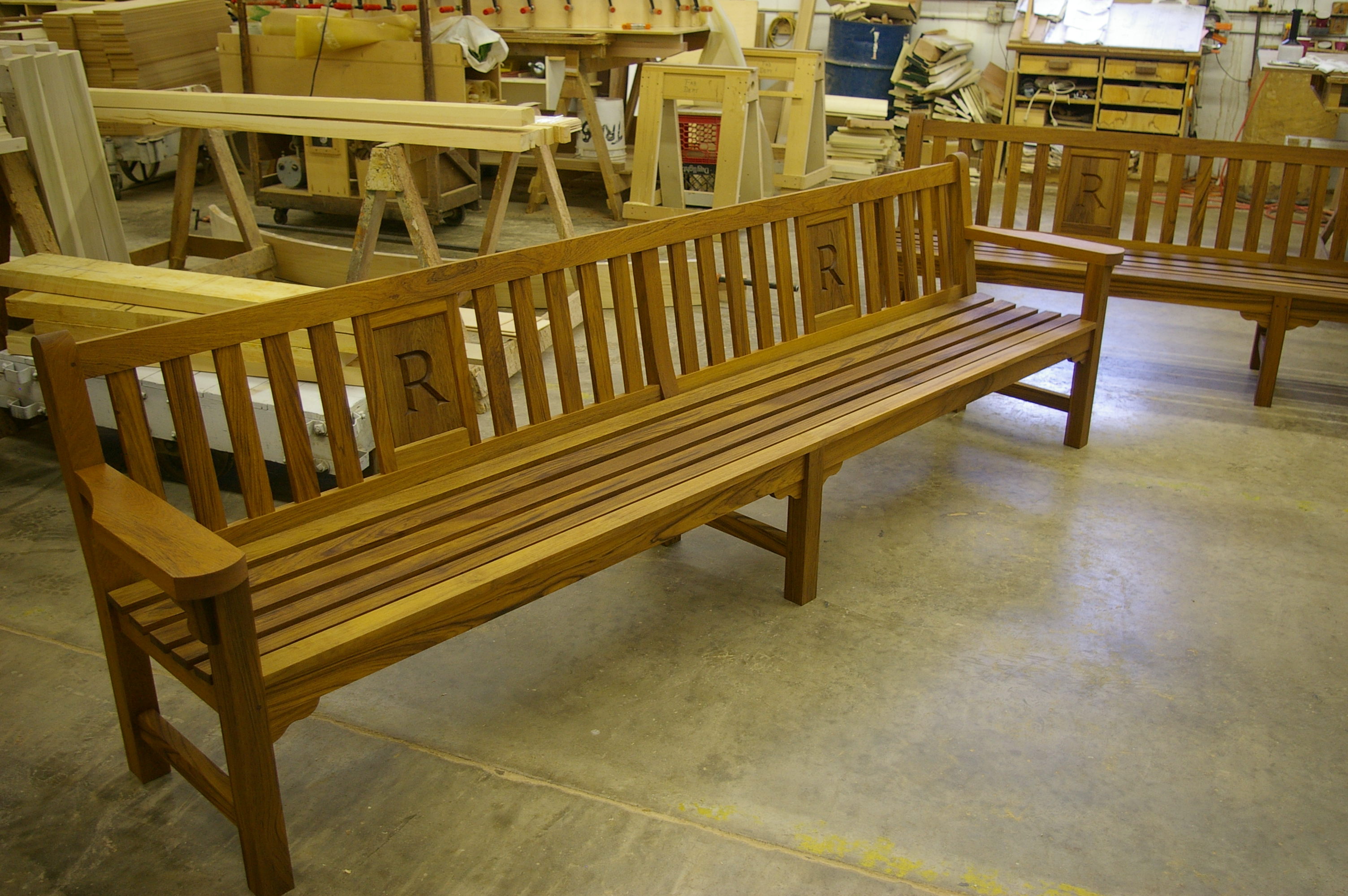 Milled round Teak rail section held in the hand, showing the profile